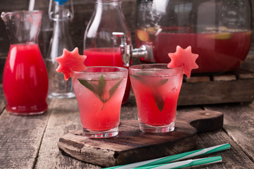 Watermelon drink in glasses with slices of watermelon mint and lemon,