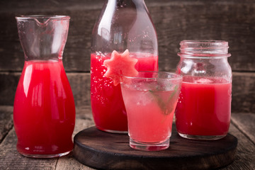 Watermelon drink in glasses with slices of watermelon mint and lemon,