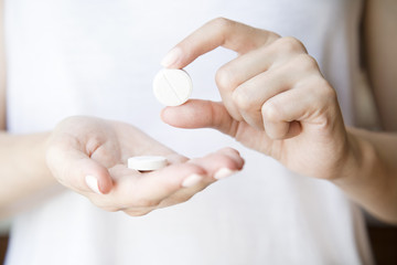 Pills in women's hands.
