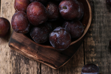 ripe plums on wooden vintage background
