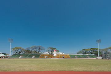Obraz premium football field with green grass and lamp posts