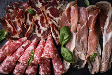 Traditional spanish tapas or italian antipasti on wooden vintage table