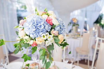 fresh floral composition on the holiday table. Beautifully organized event - served banquet tables ready for guests