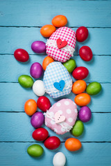 easter concept with colorful handmade eggs and rabbit on wooden table