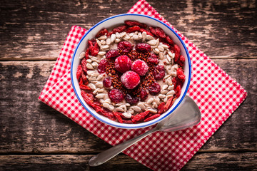 Breakfast banana smoothie bowl topped with goji berries,raspberry