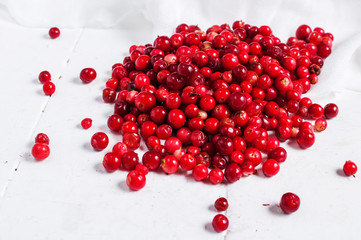 fresh cowberry on wooden background, selective focus
