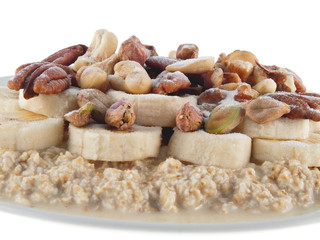 oat flakes in soy milk with banana, nuts and grape sugar