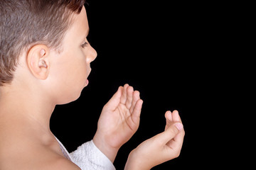 Cute Muslim Kid Praying While Wearing Ihram ( White Traditional Islamic Clothes ) During Hajj