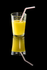 solemn glass of fresh orange juice with a straw