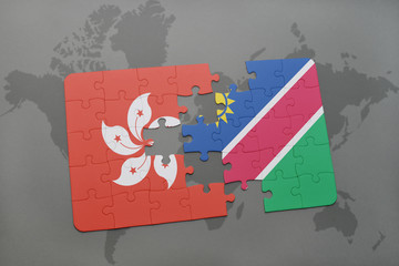 puzzle with the national flag of hong kong and namibia on a world map background.