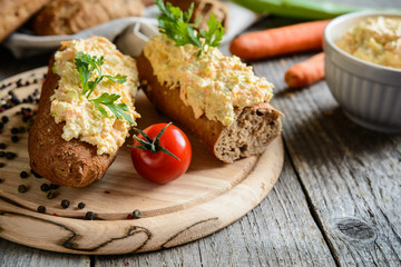 Whole wheat baguette with curd spread, eggs, carrot, green onion, pickled cucumber and mayonnaise