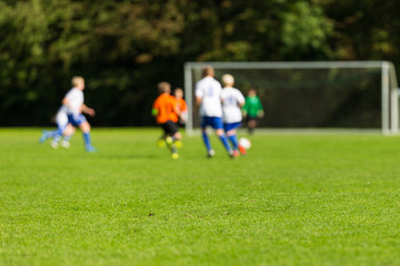 Obraz na płótnie Canvas Blurred youth soccer players