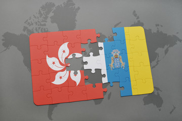 puzzle with the national flag of hong kong and canary islands on a world map background.