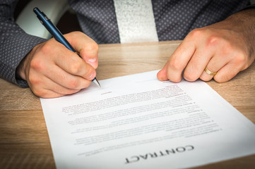 Businessman is signing a contract to conclude a deal