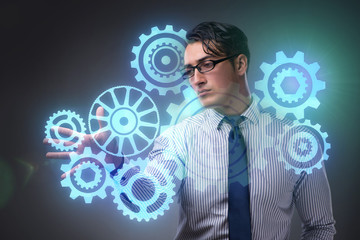 Businessman with cogwheels gear in teamwork concept