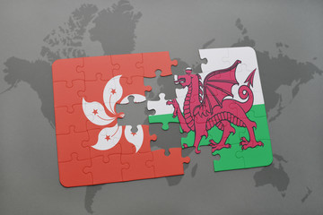 puzzle with the national flag of hong kong and wales on a world map background.