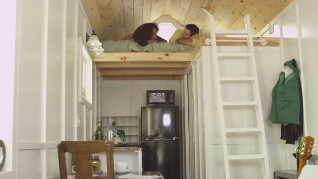 Young couple chatting on a loft mattress