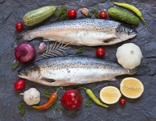 Fresh uncooked fish on black background, top view