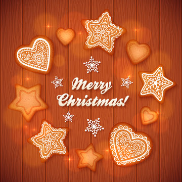 Christmas gingerbread stars and hearts greeting card on wooden background