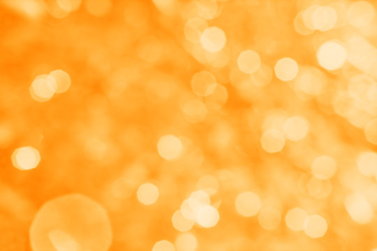 Abstract orange background with white bokeh