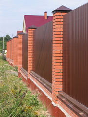 Fence with brick pillars