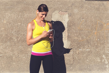  Sports woman listening to music during the workout.