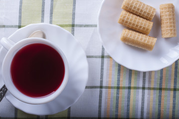 Standing on the table white Cup of tea hibiscus. The view from the top