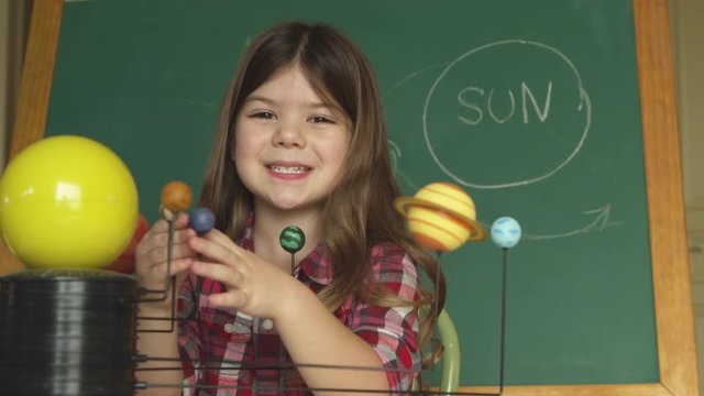 young girl learning about the solar system and planets