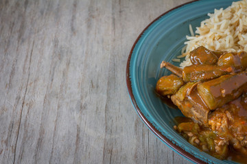 Bamiya with Rice on a Rustic Wooden Table with Copy Space Horizontal