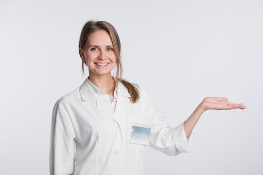 Young Doctor Woman Nurse Presenting And Showing Copy Space For Product Or Text. Caucasian Female Medical Professional Isolated On White Background.