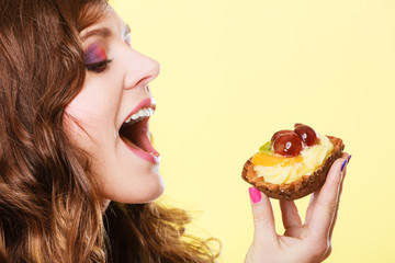 Closeup woman eating fruit cake sweet food