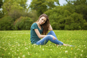 Fototapeta premium Young beautiful brown haired woman in blue jeans