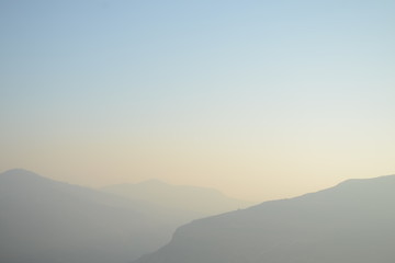 Hazy Muted Mountain Range Fading into the Distance at Sunset