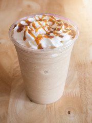Coffee caramel frappe with whipped cream in a coffee shop