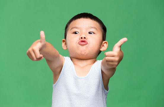 Little boy showing thumb up gesture
