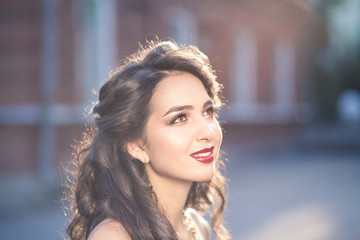 Obraz premium Portrait of young beautiful woman twenty five years old with dark brown or black hair outdoors on sunset. Lifestyle concept