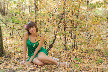 Naklejka na ściany i meble Beautiful girl in autumn park