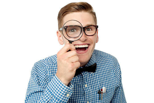 Nerd looking with loupe.