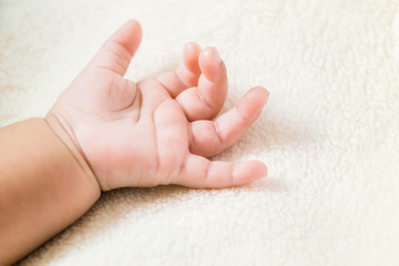 Baby hand (Selected focus) with a copy space.