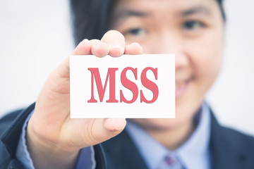 Businesswoman holding card with Management Self Service (MSS) message.