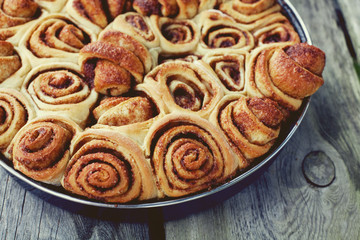 cinnamon buns on wooden surface