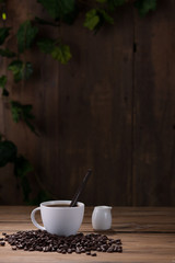 Coffee cup and coffee beans on wooden background