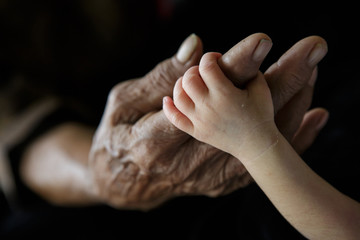Fototapeta premium Grandmother holding Grandchild (Soft focus and blurry)