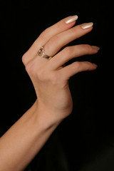 female hand holding fingers diamond ring