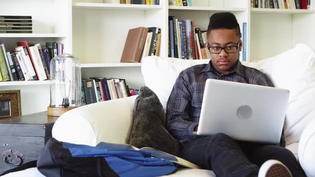 African american teenager using laptop