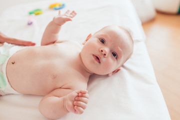 Woman doing exercises and massage the baby