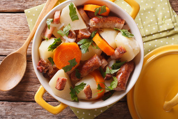 Portion of the Dublin coddle close-up in a yellow pot. Horizontal top view
