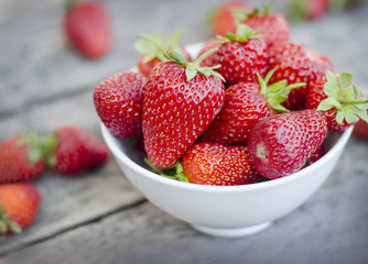 Ripe red strawberries on wooden table