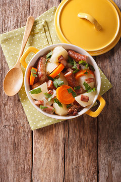 Traditional Irish dish is coddle with sausages, bacon and vegetables. Vertical top view
