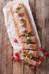 Sweet sliced pie stuffed with ripe raspberry close up. vertical top view
